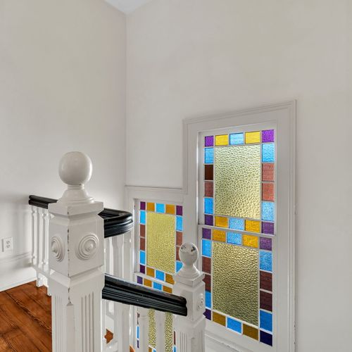 Colorful stained glass adds charm to this elegant staircase.