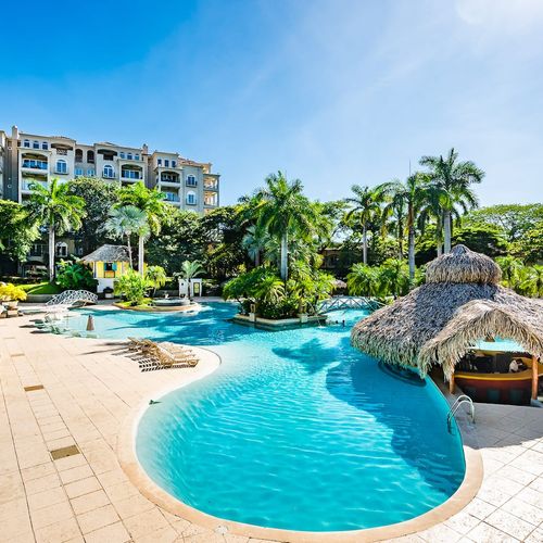 The pool is surrounded by plants and trees. It offers lots of shade.