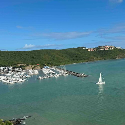 Peaceful Panoramas: Relax and take in the calming sight of the sea and the graceful movement of boats from afar.
