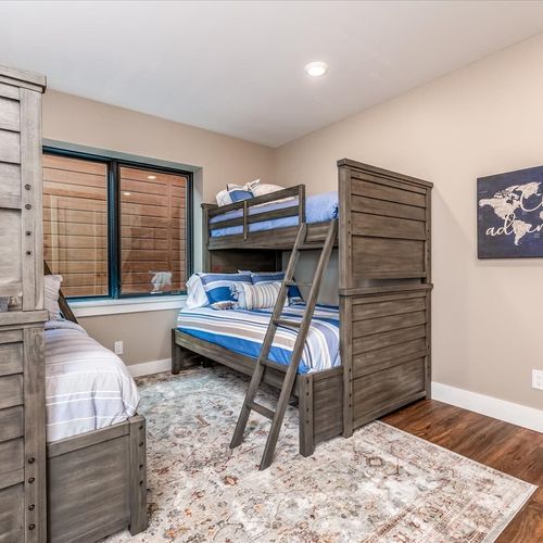 - perfect kid friendly room with two twin over full bunks for flexible sleeping
- sturdy wood frames and blue striped bedding give it a fun coastal lodge look
- great for cousins, siblings, or friends traveling together in one cozy space