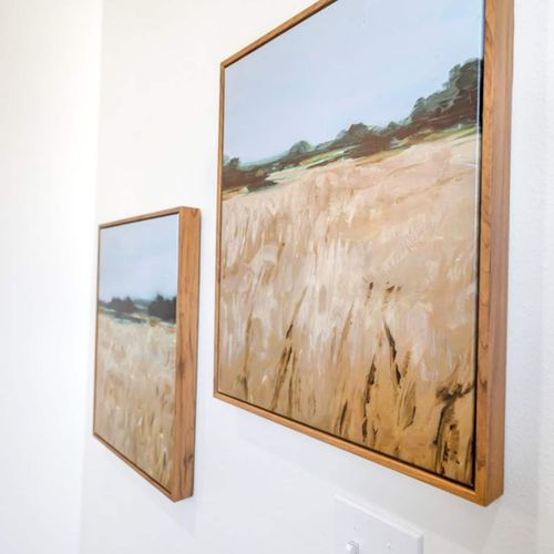Statement artwork w/ warm golden tones adding depth & character to the space.