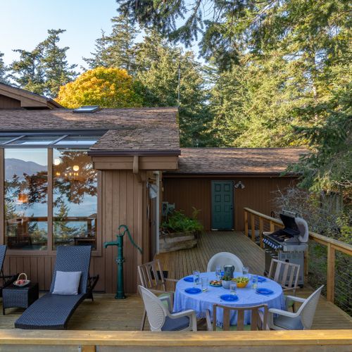 Outdoor dining with BBQ and place settings.