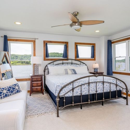 Bedroom #1 (second floor):  the home has a gorgeous master bedroom with a king-size bed, sofa, ceiling fan, dresser, closet, great views of betsie lake, and its own private en suite bathroom with a jetted tub!