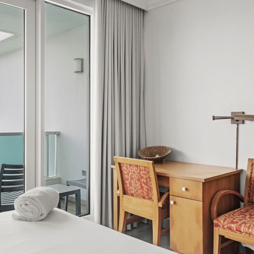 Cozy workstation by the balcony doors, offering a perfect blend of work and views.