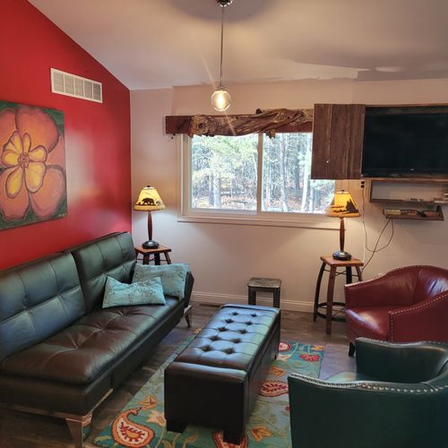 Living room #1 (second floor):  beautiful and colorful living room with an ottoman and flat screen television.