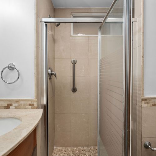 Clean and modern bathroom with a spacious walk-in shower for a refreshing start to your day.