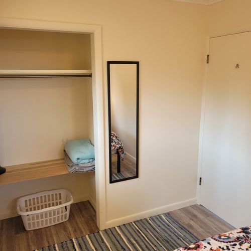 Bedroom #1:  features a queen-size bed, nightstands, lamps, mirror, and closet.