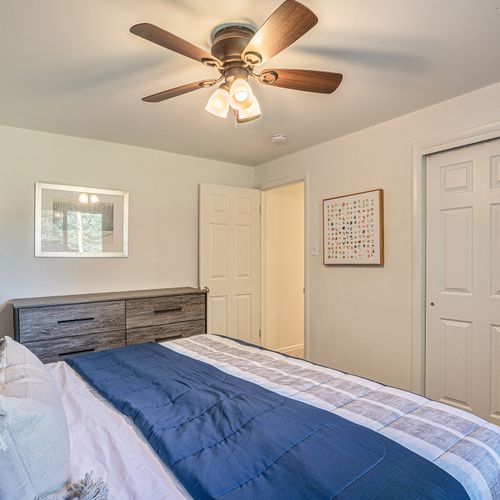 Experience a well-lit and stylish space in this upper-level bedroom, complete with modern decor and lots of closet space.