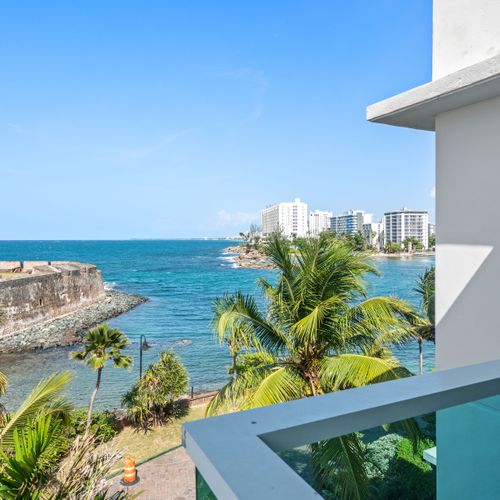 Embrace the beauty of the coastline from your balcony, where historic architecture meets the endless ocean. A captivating view.