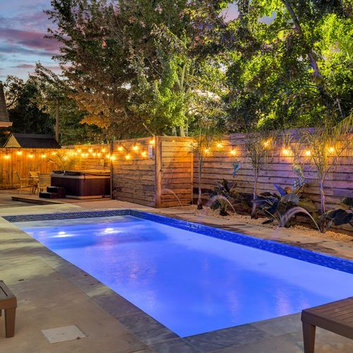 Evenings by the pool just got better. Take a dip in the glow of string lights and unwind in this serene oasis—your perfect spot to soak up New Orleans nights