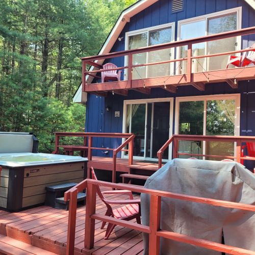 Exterior:  the back deck and hot tub in the summer.