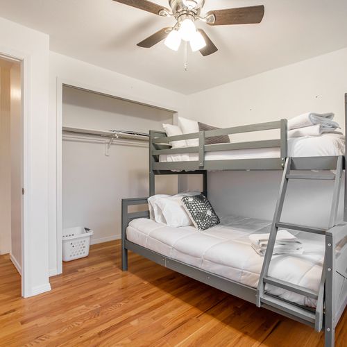 This secondary bedroom includes a bunk bed with a full and a twin sized mattress.