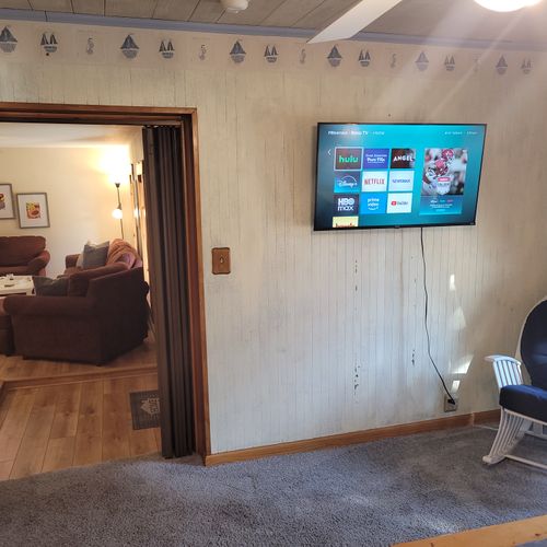 BEDROOM #1 (MAIN FLOOR):  Features a queen-size bed, dresser, mirror, closet, rocking chair, private ensuite bathroom, and private live-streaming television.  (Note that there is a collapsing curtain between the bedroom and the living room.)