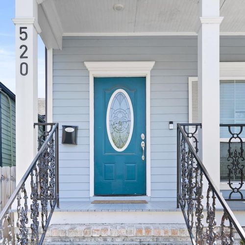 Welcoming teal front door sets the tone the moment you arrive.