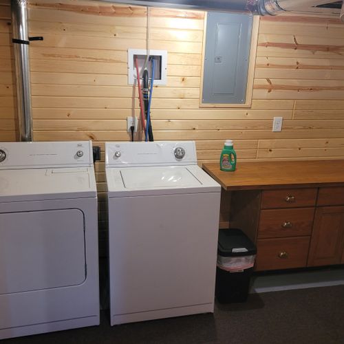 Laundry room:  there is a large laundry room in the basement that includes a washer, dryer, folding area, iron, and ironing board.