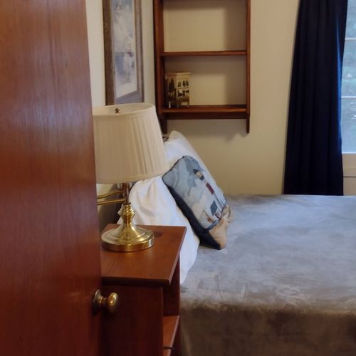 Bedroom #1:  features a full-size bed, nightstand, lamp, dresser. And closet.