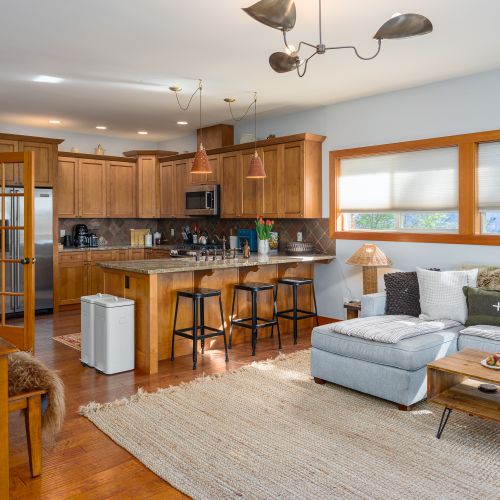 Spacious common area with dining, kitchen, and living room—easy balcony access, WiFi, and TV for your comfort.