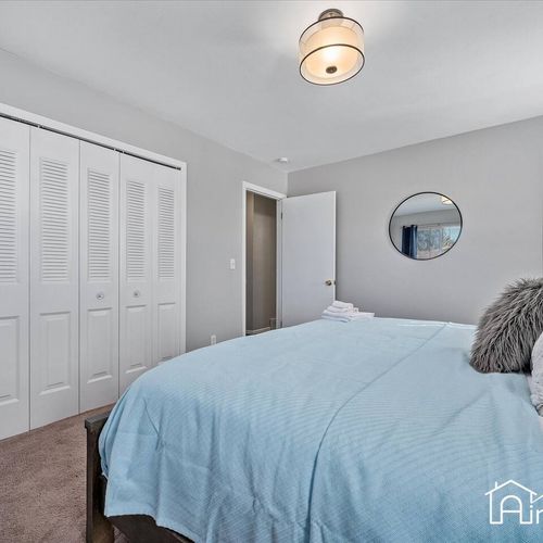 - king suite with a wide closet, plush bedding, and soft gray tones throughout
- minimalist décor and overhead light fixture keep things cozy and clutter free
- peaceful retreat to recharge between adventures or long travel days