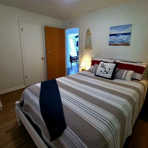 Bedroom #2:  bedroom #2 features a full-size bed, closet, dresser, and nightstands with lamps.