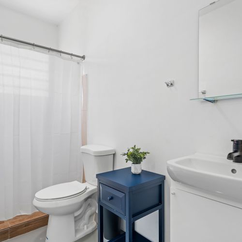 Step into a harmonious blend of comfort and modern design in this bright and inviting bathroom space, where every detail is meticulously crafted to ensure your utmost relaxation and convenience.