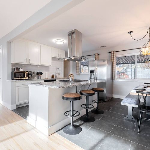 - spacious open kitchen with a granite island, bar seating, & a full dining nook
- equipped with stainless appliances, gas cooktop, & essentials for every meal
- warm lighting, neutral tones, & modern fixtures make it both functional & inviting