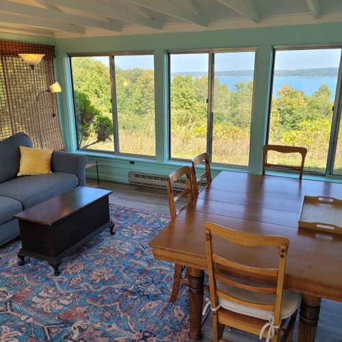 Sunroom:  the cottage has a very fun and family-friendly sunroom with a dining / game table, sofa, comfy chair, and a great view of crystal lake