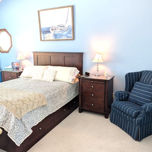 BEDROOM #2 (SECOND FLOOR):  The home has a huge primary bedroom on the second floor with a queen-size bed, private ensuite bathroom, and great views of Big Platte Lake!