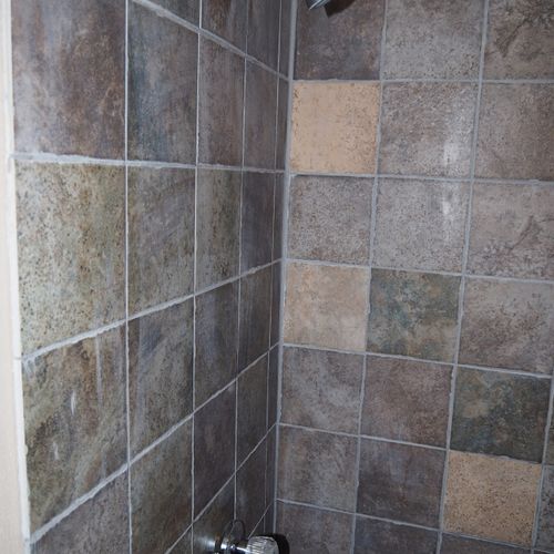 Bathroom:  features a shower and toilet. (note that there is no vanity, sink, or mirror in the bathroom. )