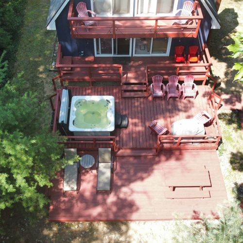 Exterior:  an aerial view of the back deck and hot tub in the summer.