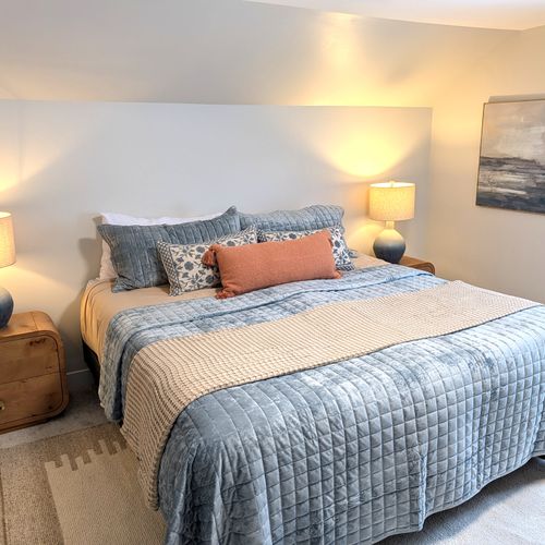 BEDROOM #2 (SECOND FLOOR):  Beautiful newly-decorated second floor bedroom with a king-size bed, private television, nightstands, lamps, dresser, and closet.