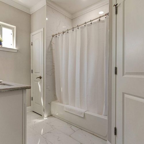Master en suite w/ a tub & shower combo for a relaxing end to the day.