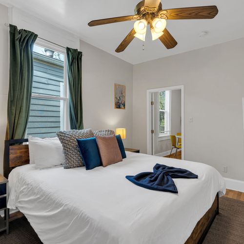 Restful bedroom w/ crisp blue & white bedding and a calm, soothing atmosphere.