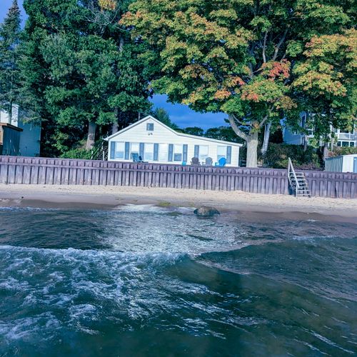 OVERALL:   Aerial view of the beach house, seawall, and private beach.