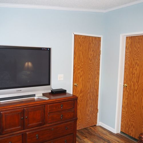 Bedroom #1 (master bedroom):  another angle showing one of the dressers, the television, the bedroom door (the door on the left), and the closet door (door on the right).