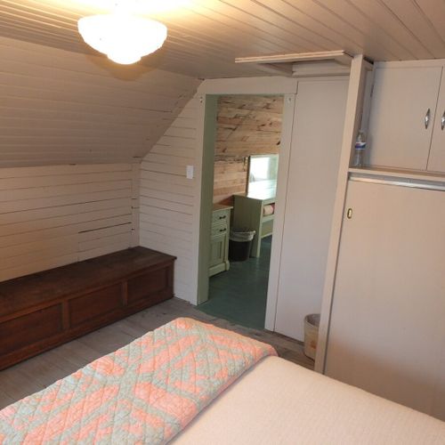 Bedroom #3 (second floor):  features a full-size bed, baby crib, dresser, mirror, and closet.