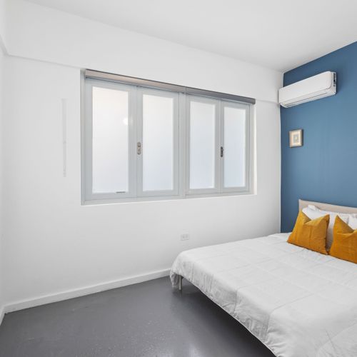 Sleek and stylish bedroom with a pop of blue.