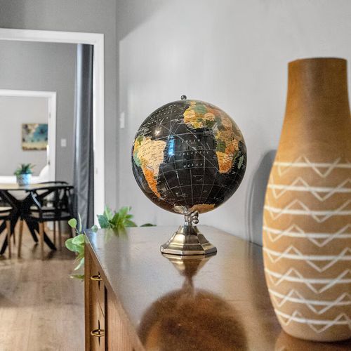 Decorative globe & woven textures add a well-traveled, eclectic vibe to the space.