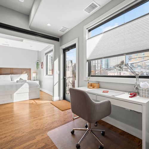 Spacious master bedroom with flexible layout, flowing into main area and workspace.