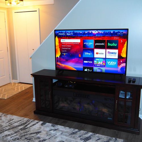 Living room:  very comfy and cozy living room with a sofa, comfy chairs, large television with living streaming, and a very cool electric fireplace.