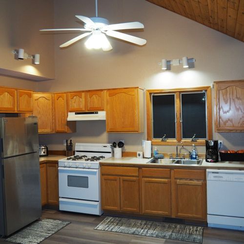 Kitchen:  full kitchen with all modern appliances including a microwave, toaster, coffee maker, and dishwasher. Also includes lots of cabinet space and a good supply of cooking and dining utensils.