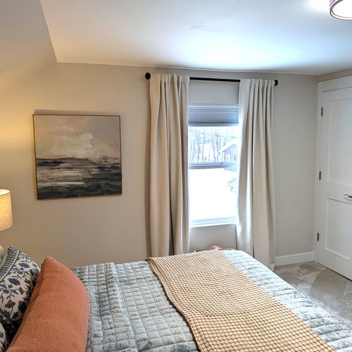 BEDROOM #2 (SECOND FLOOR):  Beautiful newly-decorated second floor bedroom with a king-size bed, private television, nightstands, lamps, dresser, and closet.