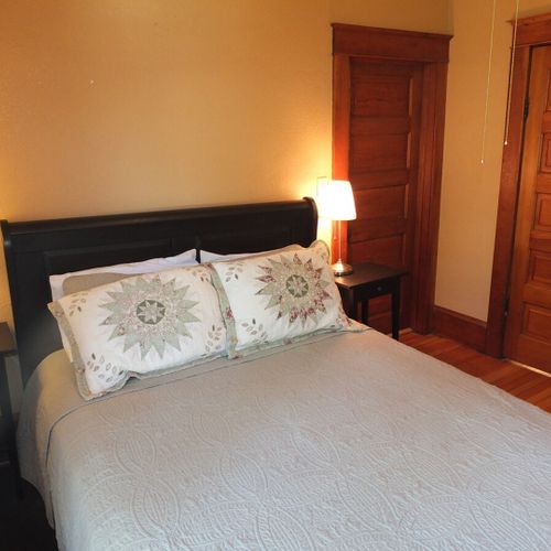 Bedroom #1 (first floor):  features a beautiful queen-size sleigh bed, nightstands, lamps, a ceiling fan with lights, dresser, chair, closet, and its own private entrance to the first floor bathroom.