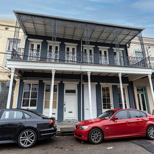 Charming exterior w/ classic New Orleans architecture & a wraparound balcony.