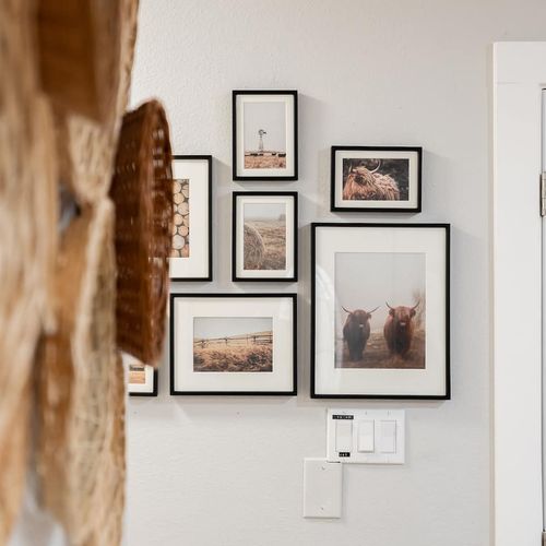 - discover a curated gallery wall with countryside inspired prints and textures
- framed photos of nature and animals bring warmth and personality to the hallway
- thoughtful blend of modern framing and rustic charm welcomes you in