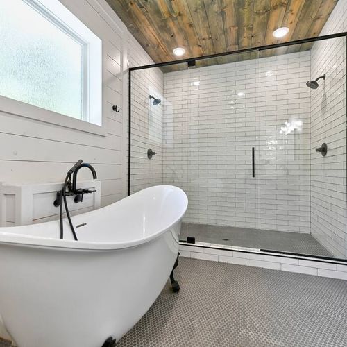 A private bathroom with a soaking tub and a walk-in shower with double heads.