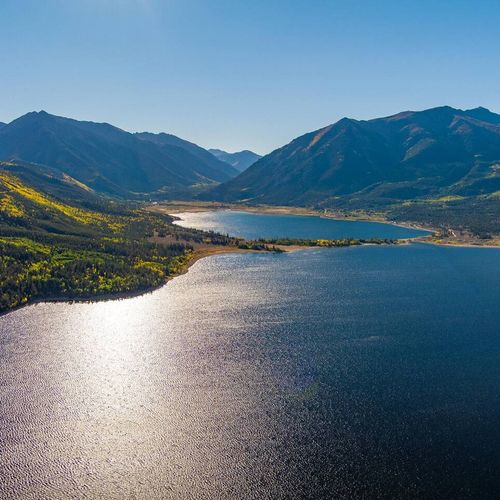 A breathtaking vista of mountains mirrored in the lake's stillness.
