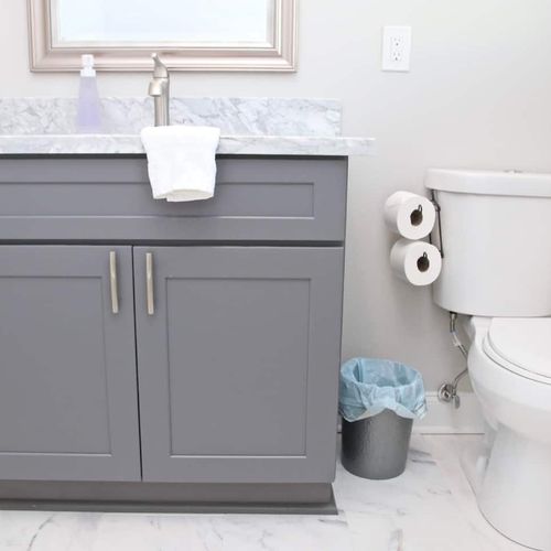 Second bathroom w/ grey cabinetry & all the essentials within reach.