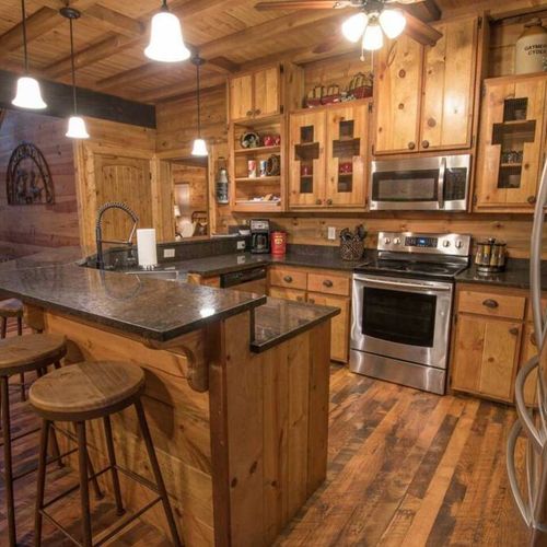The kitchen has updated appliances and a bar top for additional seating.
