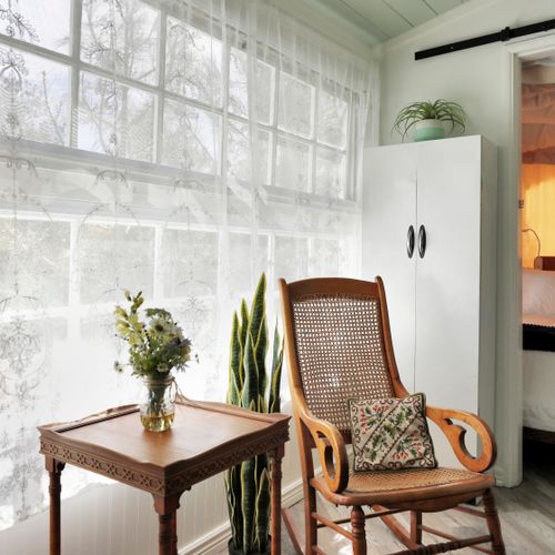 A cozy rocking chair waits by the light