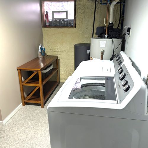 LAUNDRY ROOM (LOWER LEVEL):  Wonderfully large laundry room in the basement with a washer, dryer, and folding / ironing table with an iron as well.